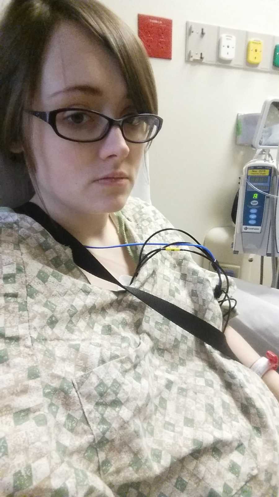 Woman takes selfie in hospital bed hooked up to monitors 