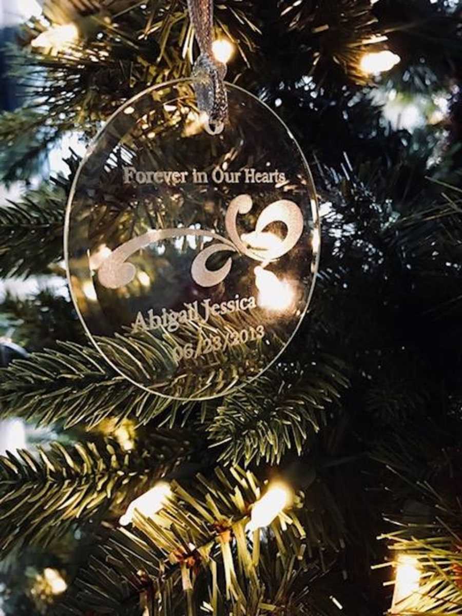 Clear engraved ornament on Christmas tree for preemie baby who died