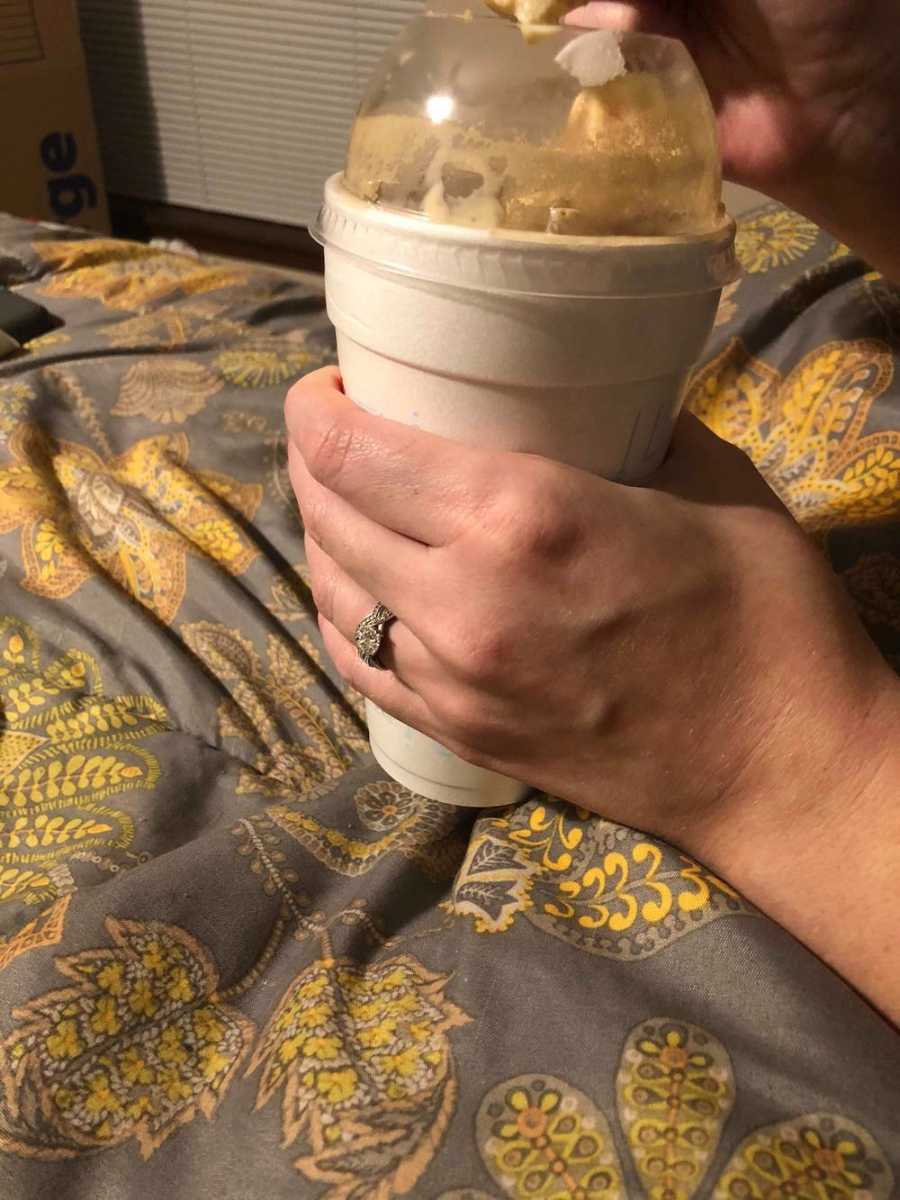 Close up of wife holding milkshake husband got for her 