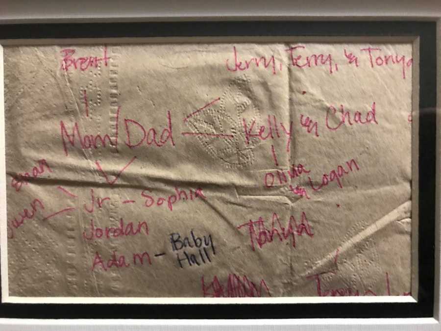 Family tree written on brown napkin in frame