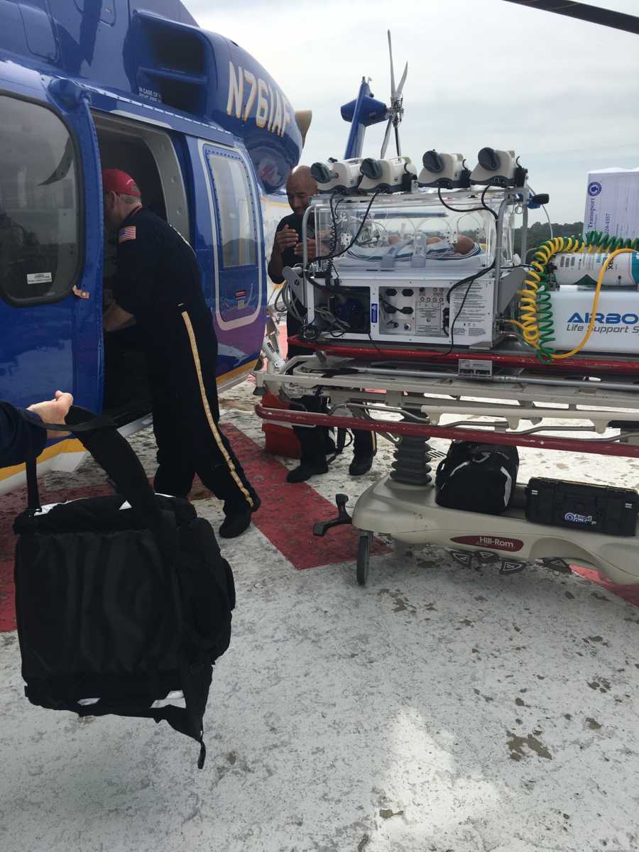 Newborn with PHTN being loaded on helicopter by EMT's to be transferred to another hospital