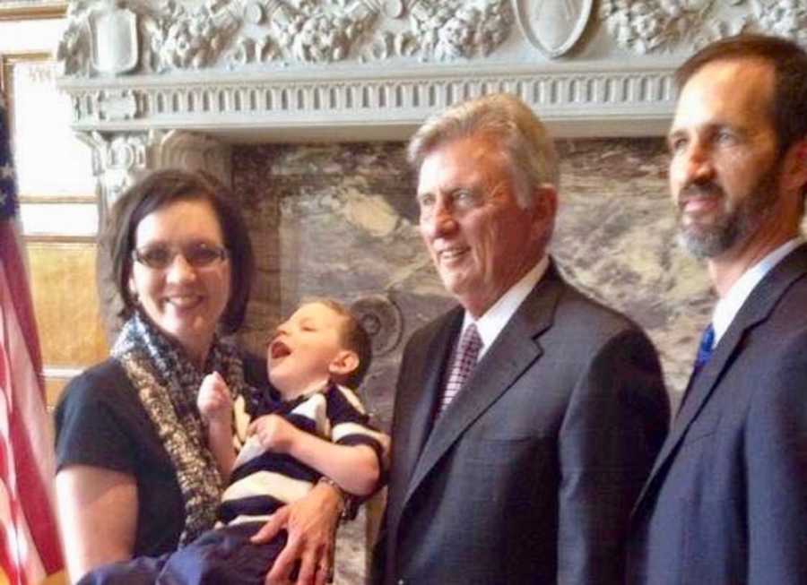 Mother holds adopted son with shaken baby syndrome with her brother and Arkansas congressman