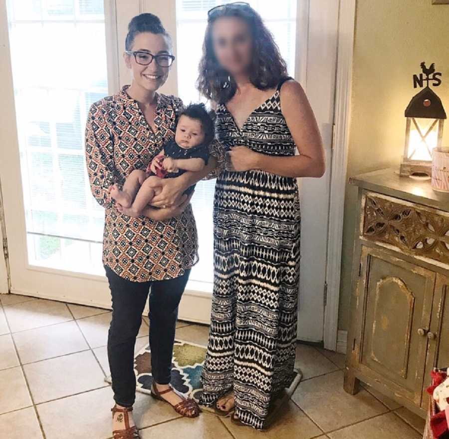 Woman stands holding newborn beside cousin who wants to give up her baby