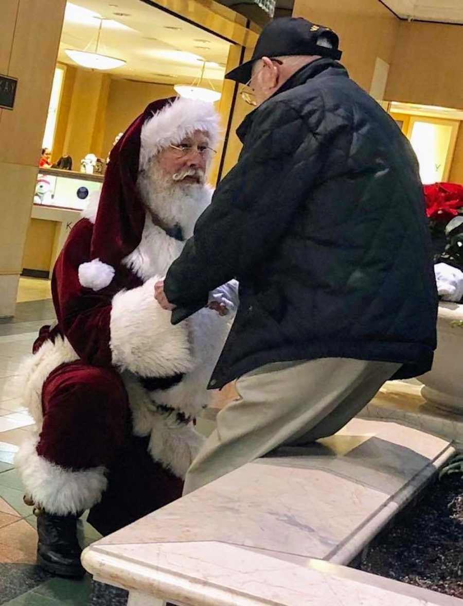 Mall Santa kneeling in front of WWII veteran 