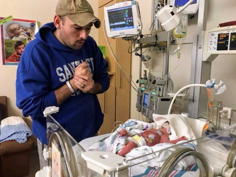 Father stands over newborn in NICU who was born in airport bathroom