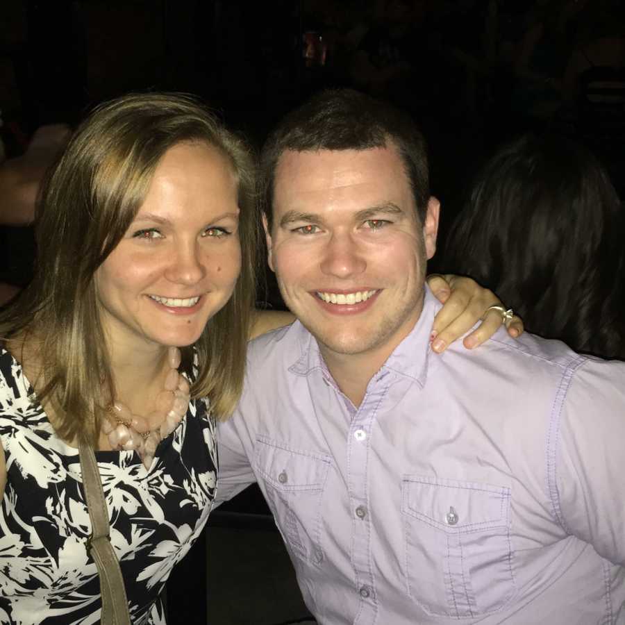 Husband and wife who sees their relationship as partnership sit smiling with arms around each other