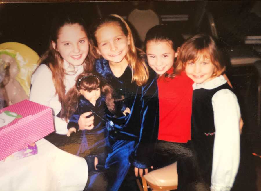 Little girl sits beside three friends