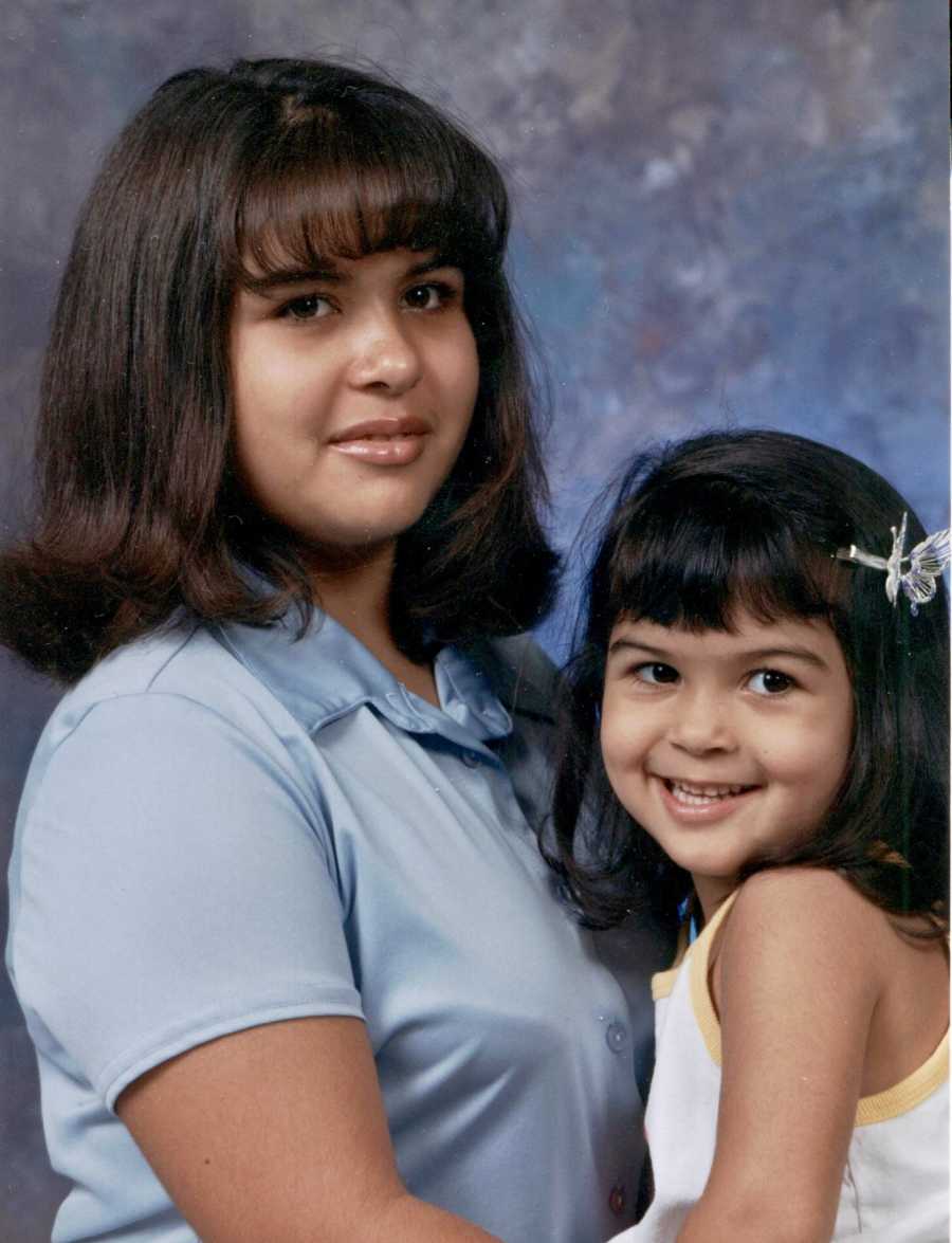 Little sister smiles with older sister who has since passed from committing suicide in photoshoot