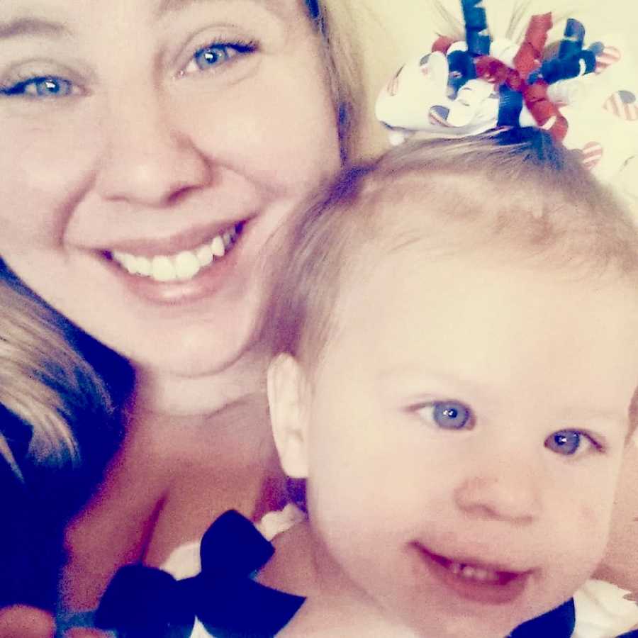 Mother smiles in selfie with baby daughter who had Hemorrhagic Stroke but was misdiagnosed