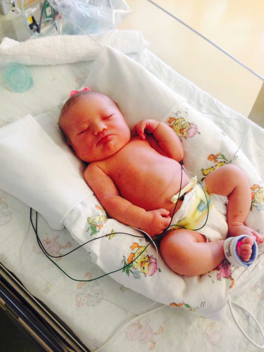 Newborn girl laying on back in NICU who needs open heart surgery