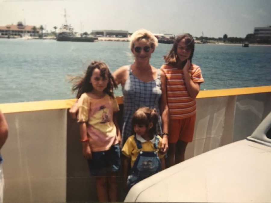 Little girl stands with her adopted mom and her two daughters on ferry