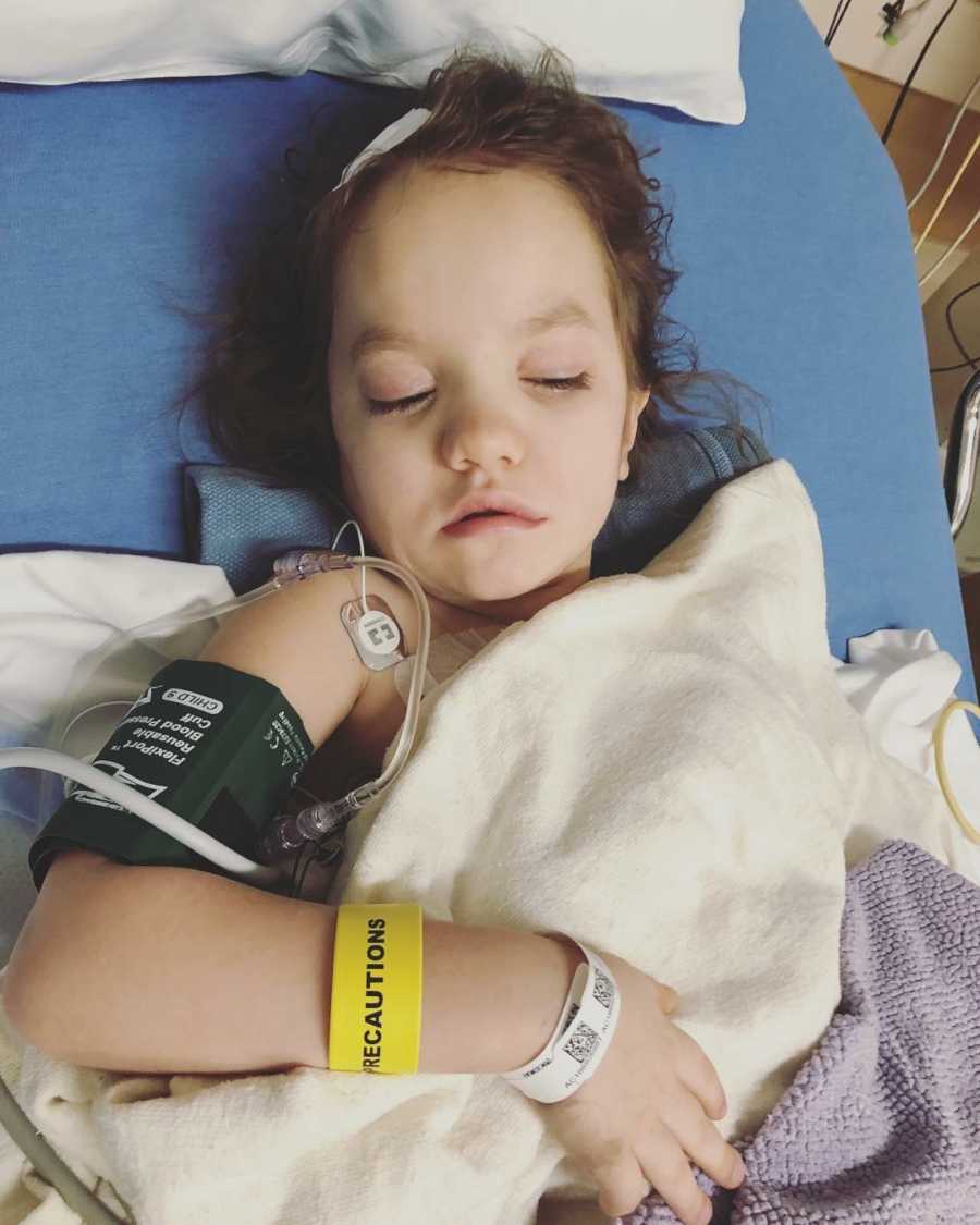 Little girl with Neurofibromatosis lays in hospital bed connected to monitors