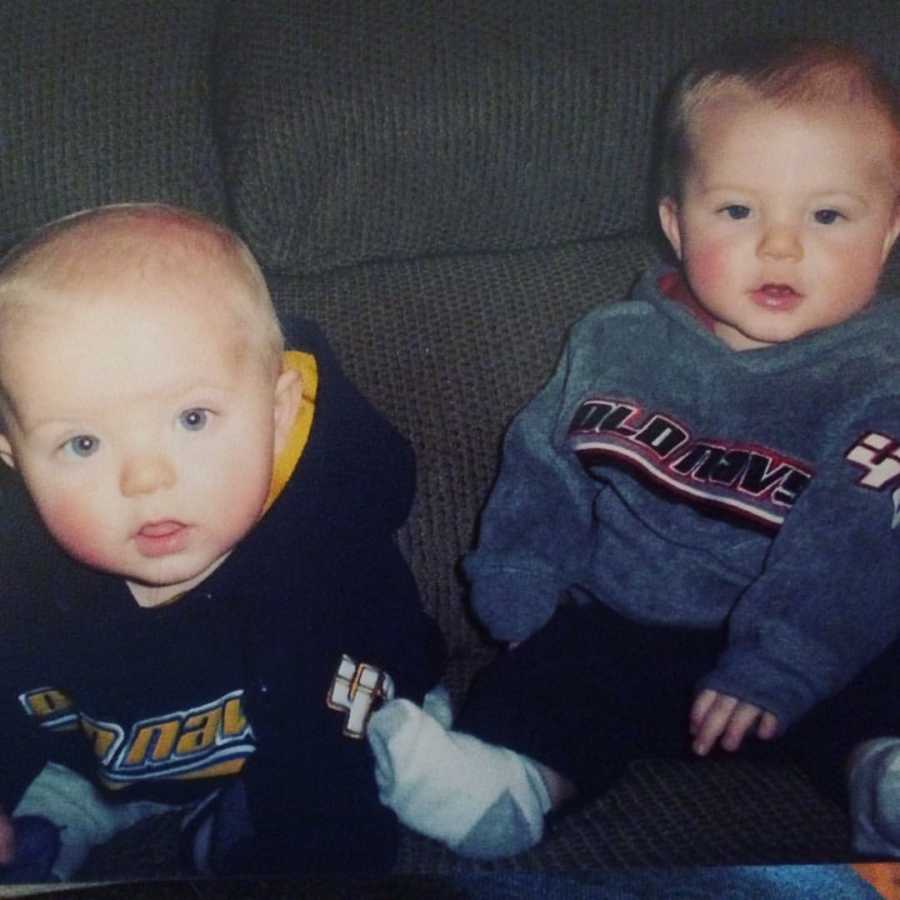 Twin baby boys sit on couch wearing Old Navy sweatshirts