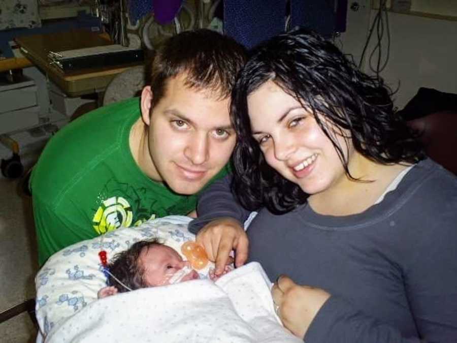 Husband and wife sit in NICU with their newborn who has very brittle bones