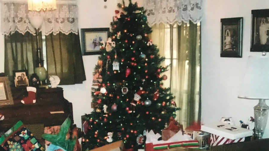 Christmas tree decorated in home surrounded by presents