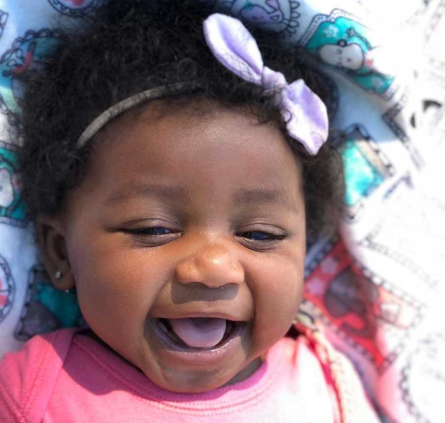 Close up of adopted baby girl laughing