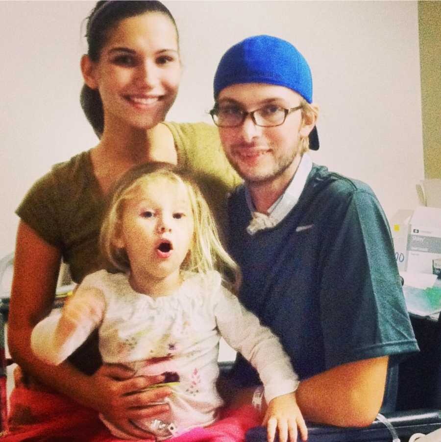 Man with Acute Disseminated Encephalomyelitis smiles beside his daughter as his wife stands beside him