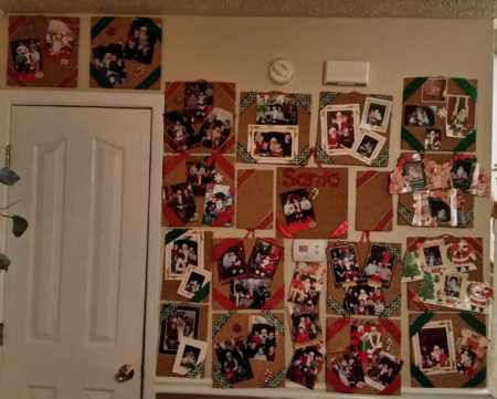 Wall covered in family home of pictures of children with mall Santa