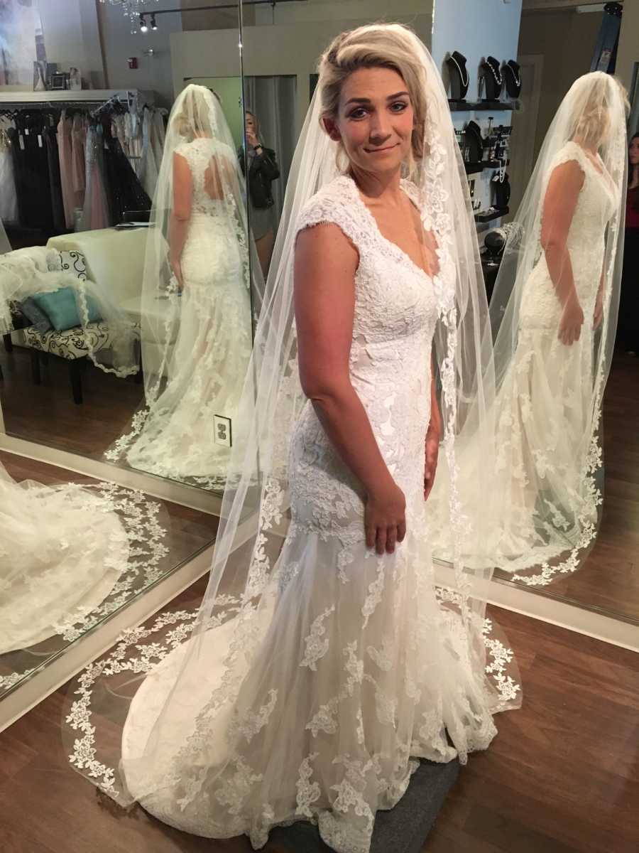Woman who struggled with her weight stands in wedding gown smiling