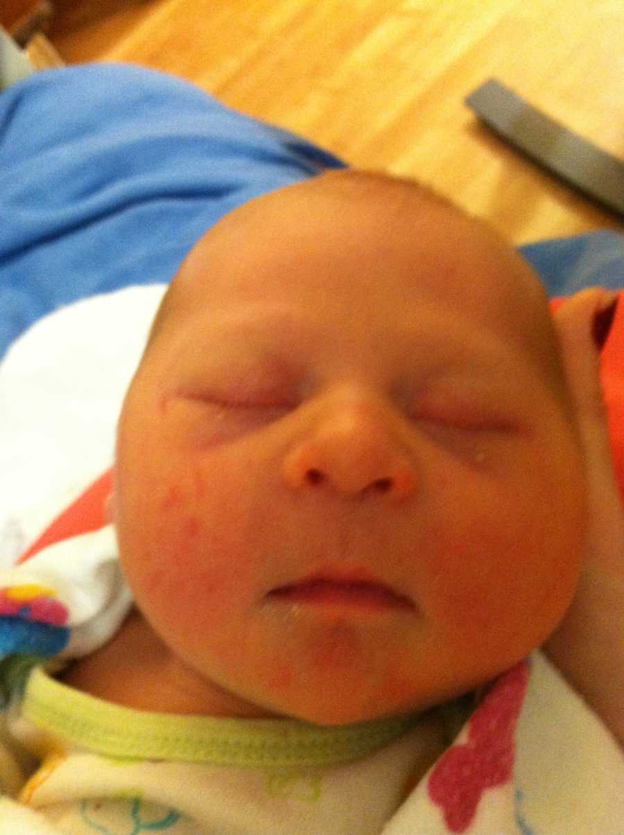 Close up of newborn's face whose mother thinks she has down syndrome