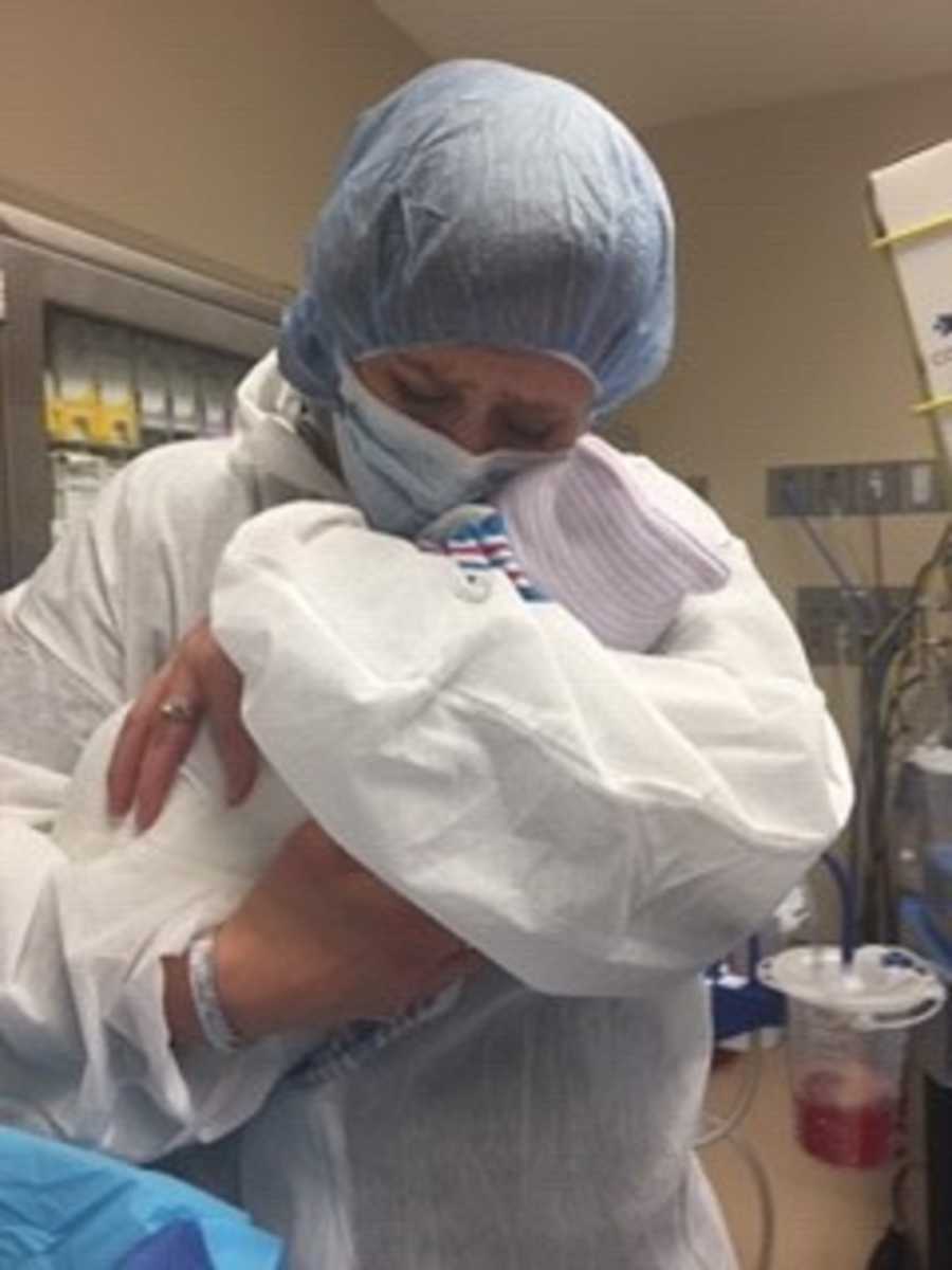 Mother cries as she holds adopted newborn baby tight to her chest