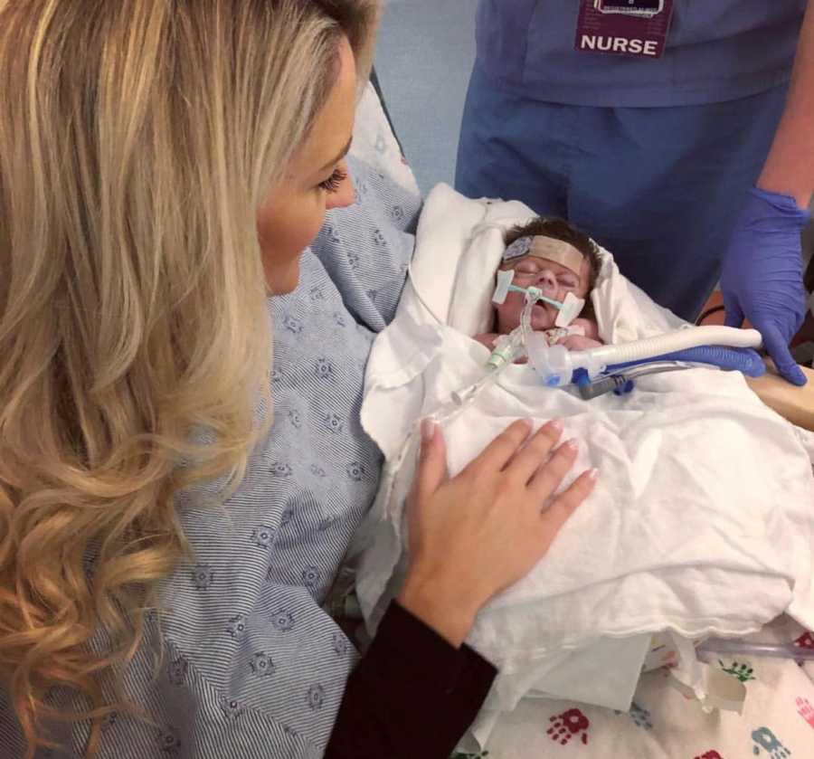 Mother holds newborn with Cornelia de Lange syndrome in her arms while sitting in NICU