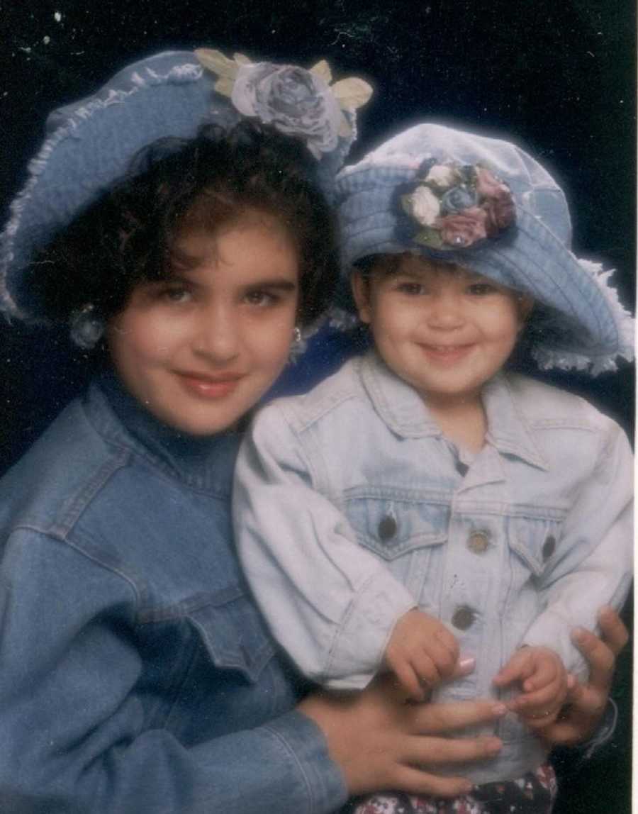 Little sister sits on lap of older sister who has since passed away from committing suicide 