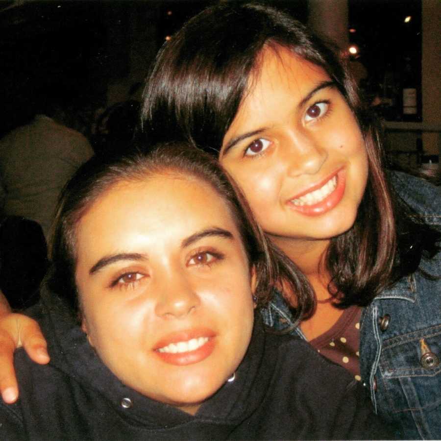 Little sister smiles beside older sister who has since passed from committing suicide