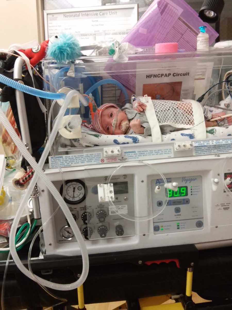 Naturally born newborn lays in NICU