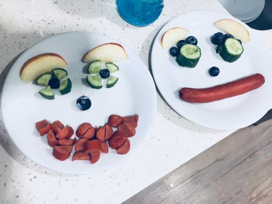 Two plates of food on kitchen counter that is arranged into face for kids