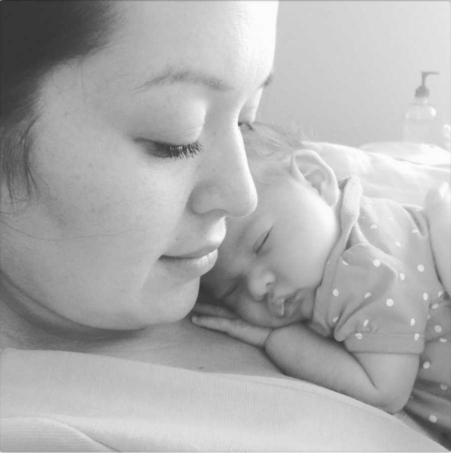 Baby girl lays asleep on mother's chest