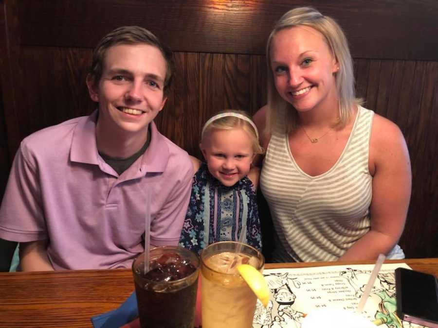 Woman sits in booth of restaurant with daughter and her brother who is addicted to drugs