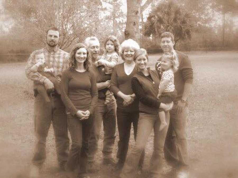 Family stands outside for family photo