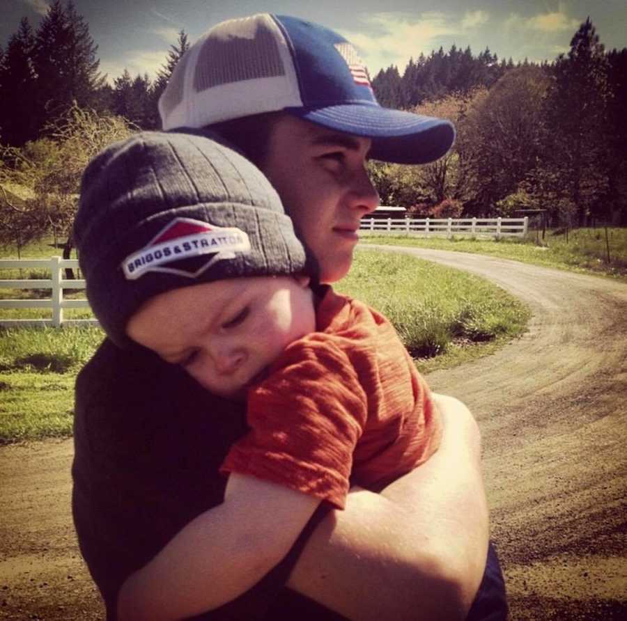 Young man who overdosed and died stands outside holding younger brother