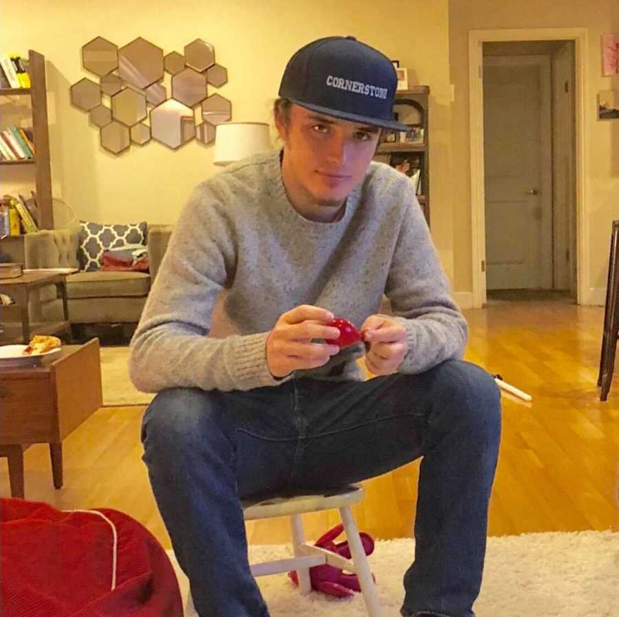 Young man who will die from overdose sits on kids chair in home