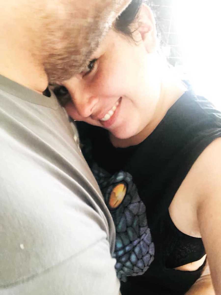Woman smiles in selfie as she hugs husband who she loves but get annoyed with