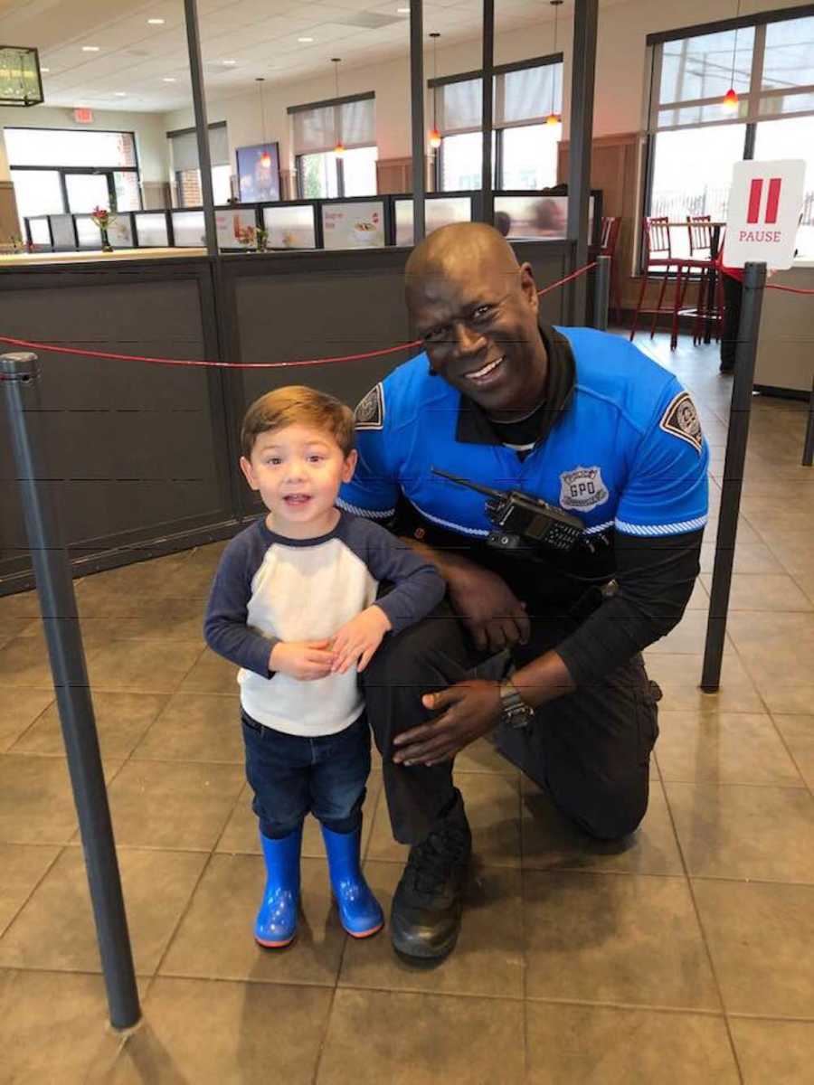 Cop kneels beside young boy in Chik-Fil-A line