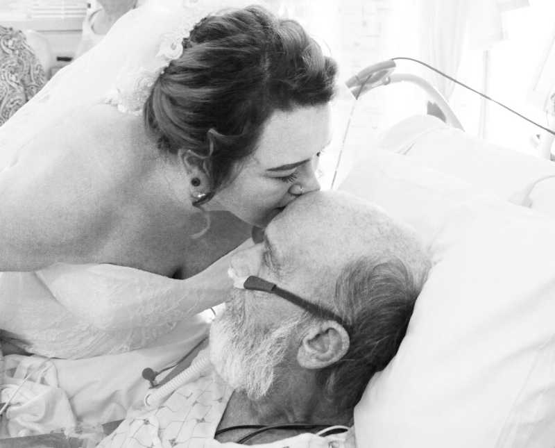 Bride kisses father with lung issues on forehead as he lays in hospital bed