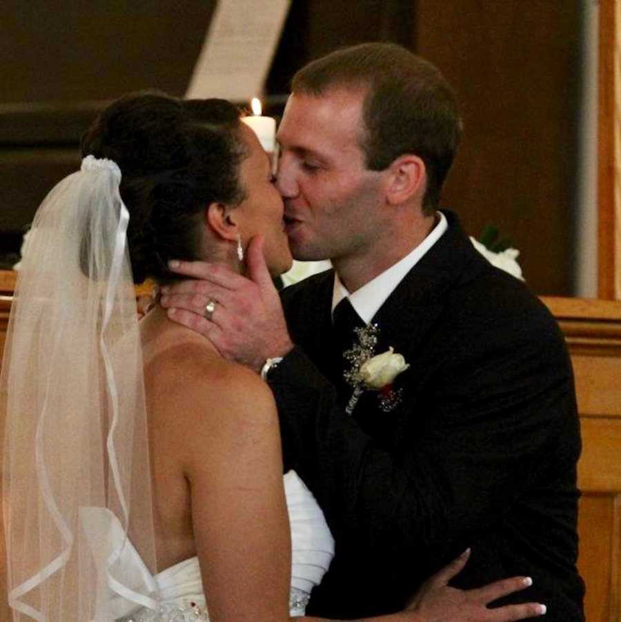 Bride and groom share first kiss in church