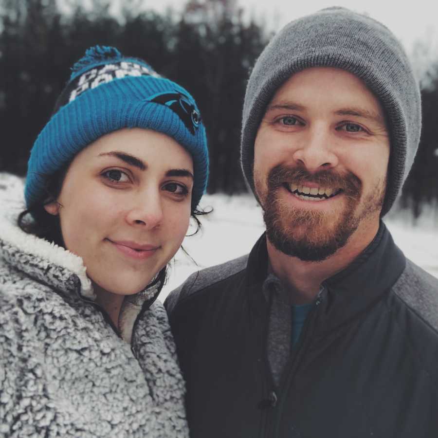 Husband and wife smile in selfie outside in winter weather