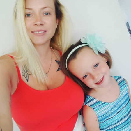 Mother who was a drug addict smiles beside daughter