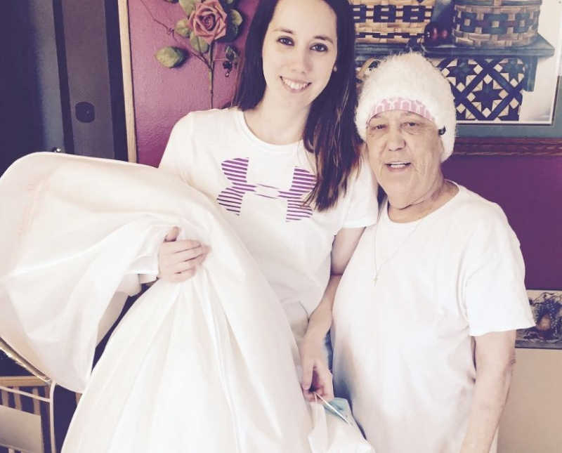 Young woman stands beside grandmother with lung cancer