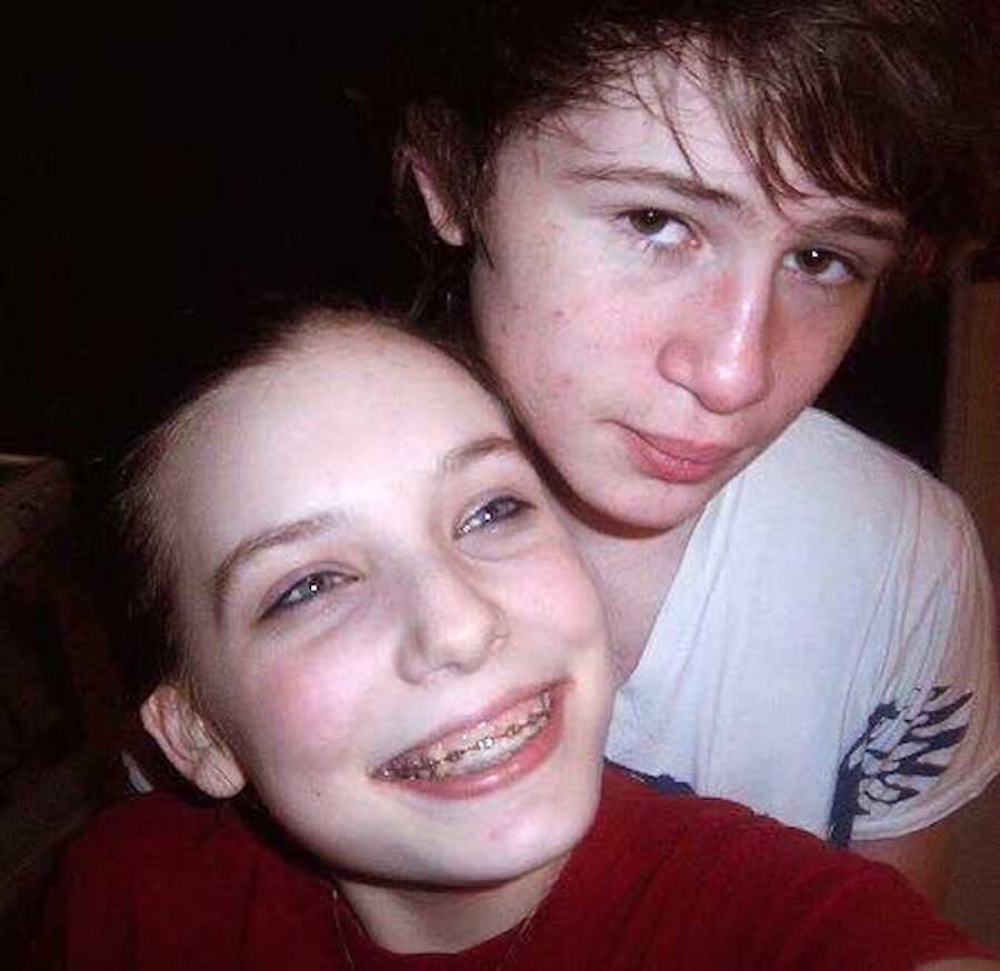 Teen boyfriend and girlfriend smile in selfie