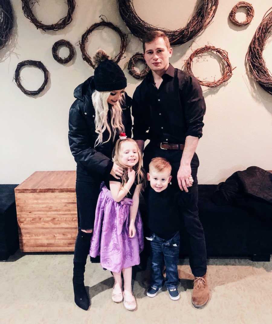 Separated mother and father stand with their daughter in son standing in front of them