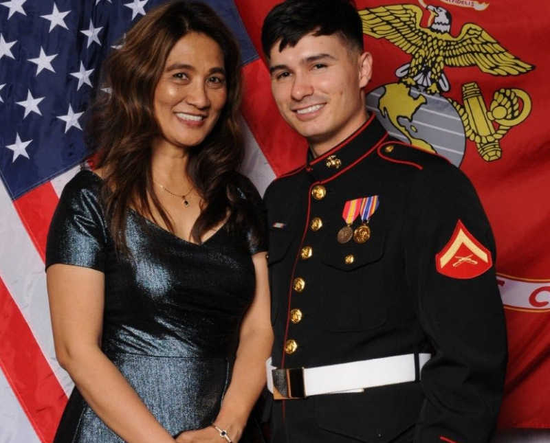 Mother stands beside marine son who underwent several brain surgeries