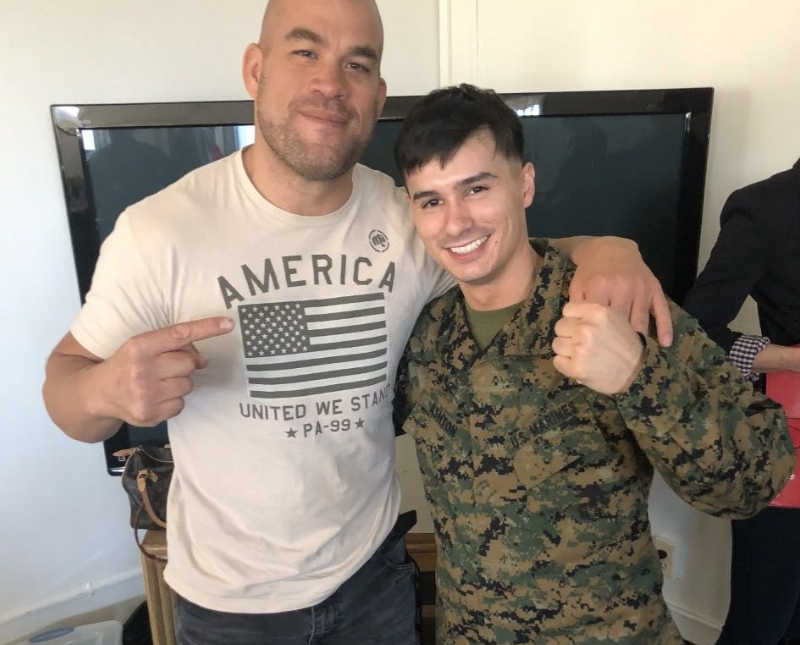 Marine man who had several brain surgeries smiles with arm around another man