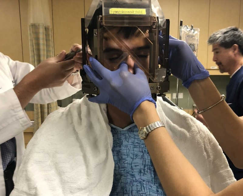 Marine sits in hospital as doctors place box over his head