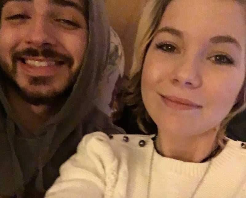 Woman smiles in selfie with her cousin she treats as brother
