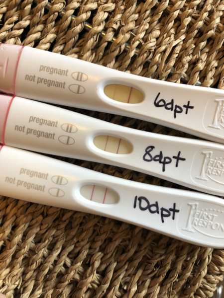 One negative pregnancy test beside two positive