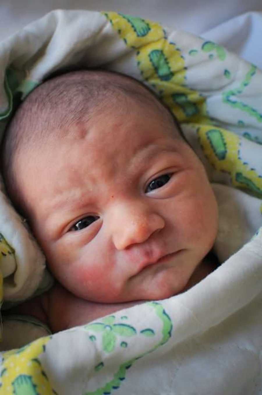 Close up of newborn baby's face who doctor's said he may have issues but doesn't